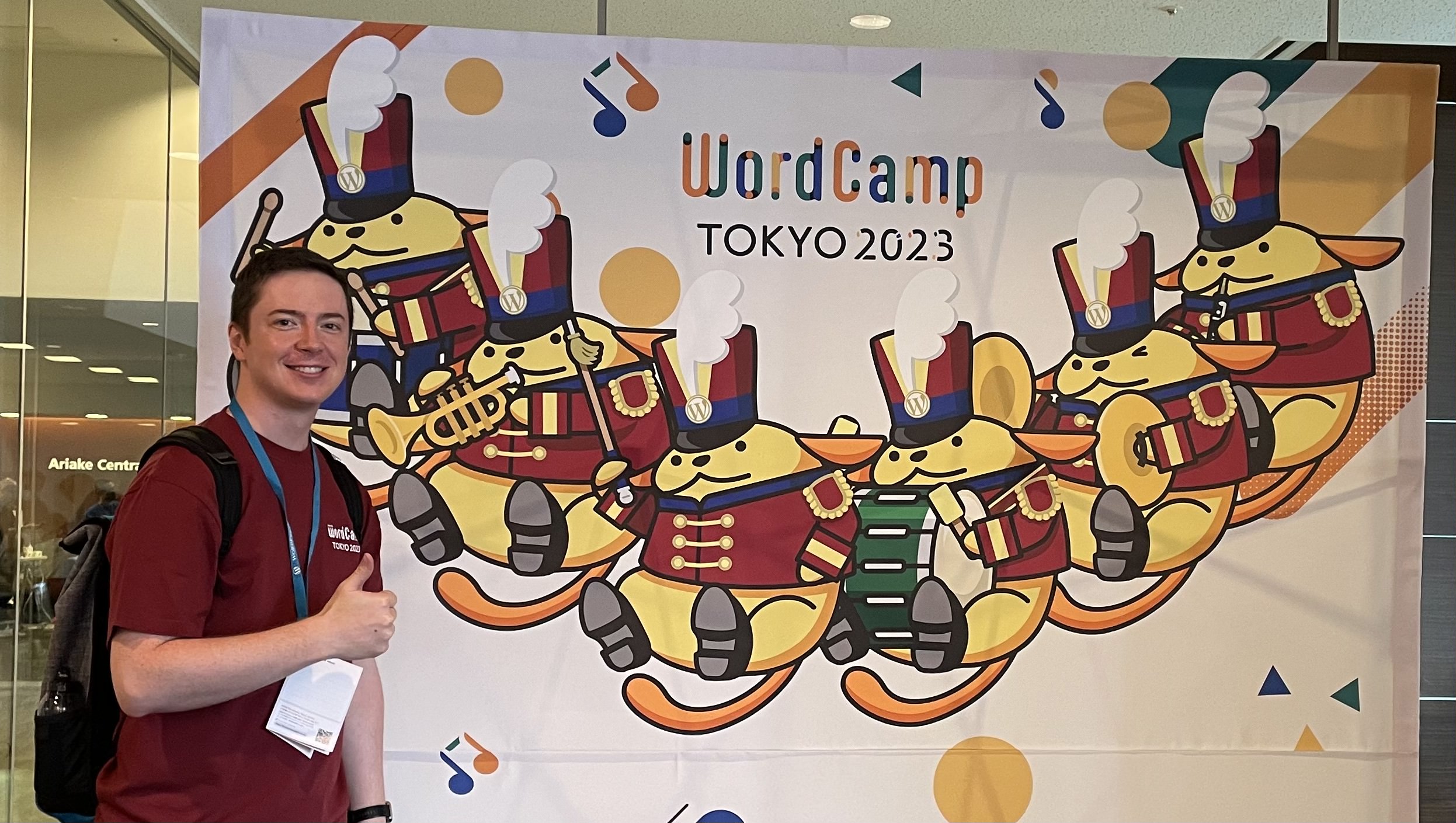 Ben standing in front of the main banner showing Wappus at WordCamp Tokyo 2023